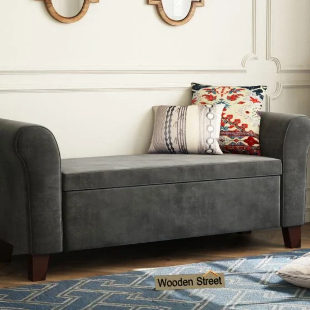 Stylish gray settee with rolled arms, high back, and built-in storage, adorned with decorative pillows, ideal for entryways, formal rooms, and boutique hotel interiors, crafted by a top sofa manufacturer.