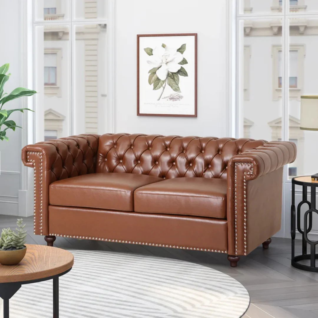 Luxury brown leather Chesterfield sofa with deep button tufting and rolled arms, crafted by a top sofa manufacturer for elegant interiors and upscale commercial spaces