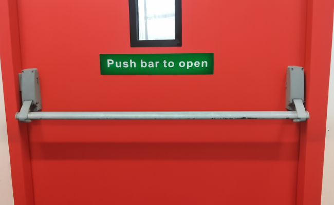 Fire-rated red exit door with a horizontal push bar handle and "Push bar to open" signage, ideal for high-traffic emergency exits and fire stair landings