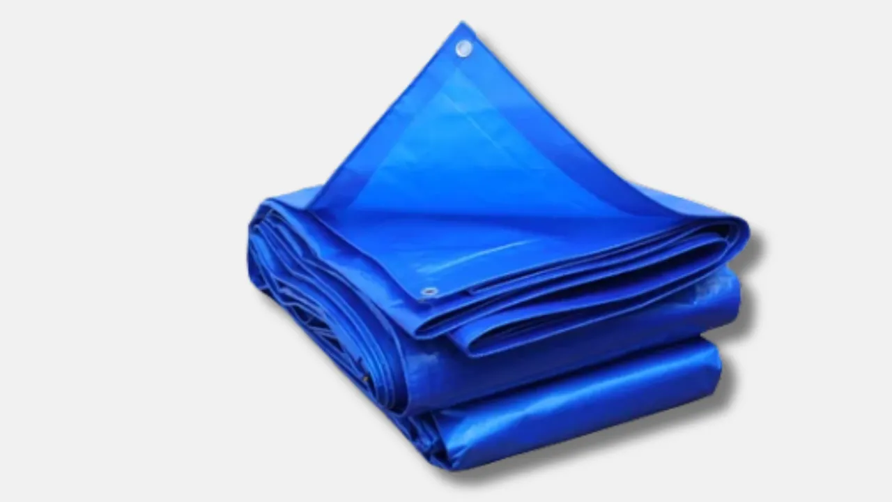 Folded blue HDPE fungimation tarpaulin with metal eyelets, manufactured by leading tarpaulin supplier in India for airtight sealing in warehouses and export industries during chemical treatments