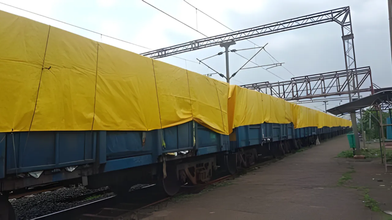 Yellow tarpaulin sheets covering cargo on railway wagons, manufactured by top tarpaulin supplier in India, providing waterproof and UV-resistant protection during transit