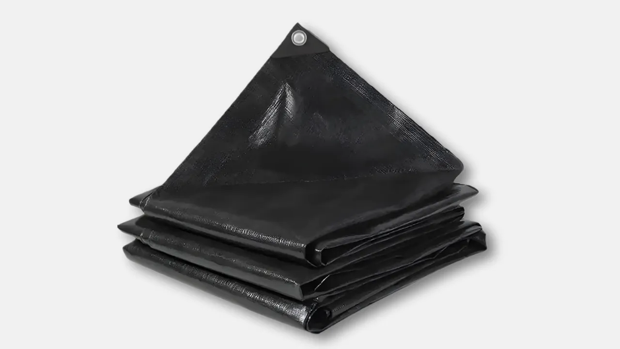 Folded black custom GSM HDPE tarpaulin with reinforced corner and metal eyelet, designed for industry-specific applications requiring tailored thickness and durability by leading HDPE tarpaulin manufacturer in India