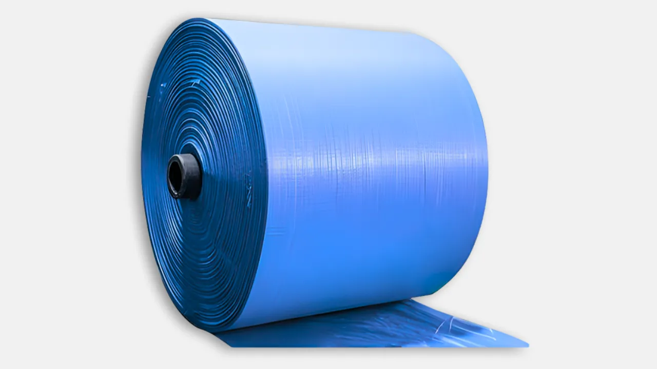 Large blue HDPE woven fabric roll designed for wide-area coverage in agriculture, construction, and industrial use, supplied by experienced HDPE woven fabric roll manufacturer in India