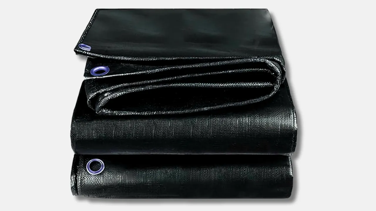 Folded black HDPE laminated tarpaulin with metal eyelets, designed for waterproof industrial storage, transport, and construction use by top HDPE tarpaulin manufacturer in India