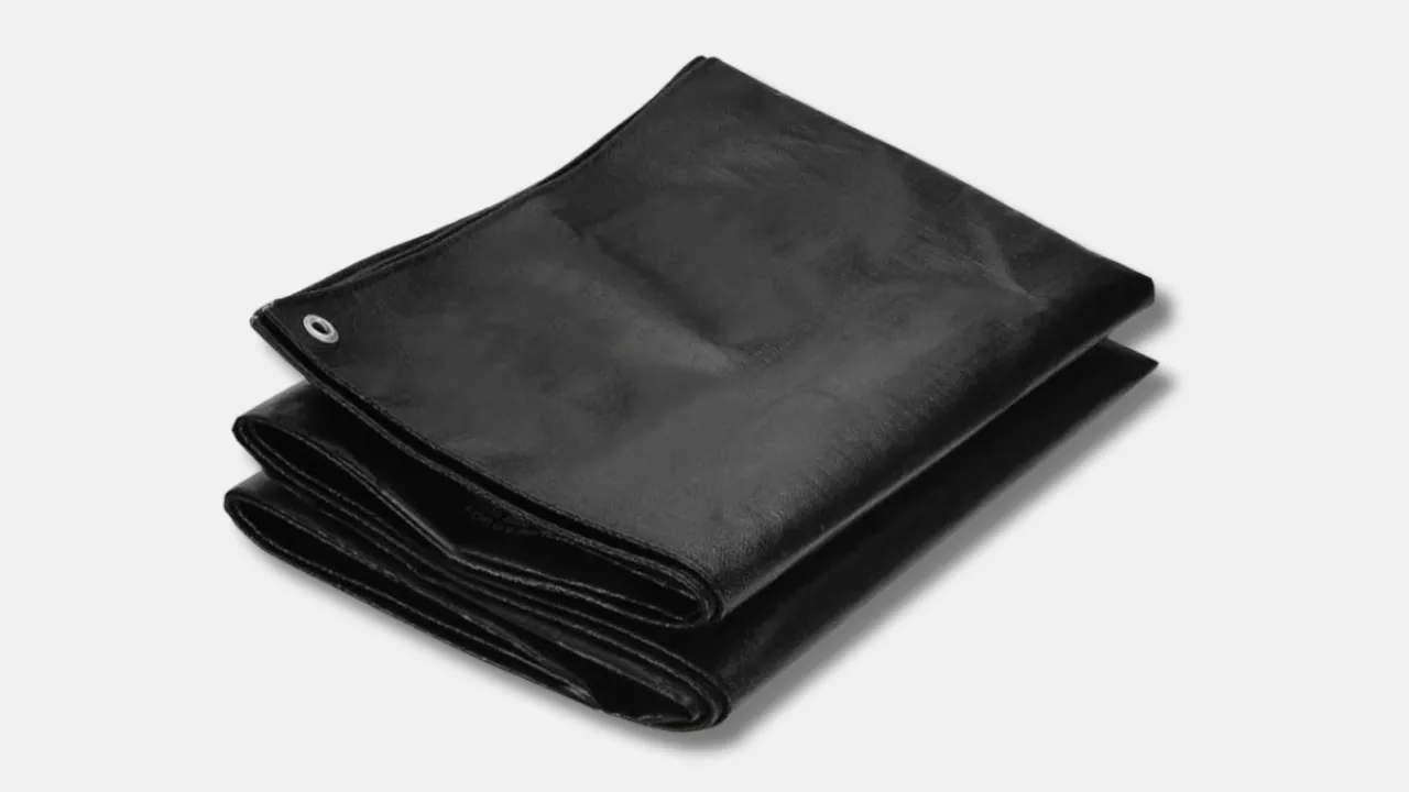 Folded heavy-duty black HDPE tarpaulin with metal eyelet, built for tear resistance and rough handling in construction, warehousing, and transport, by trusted HDPE tarpaulin manufacturer in India