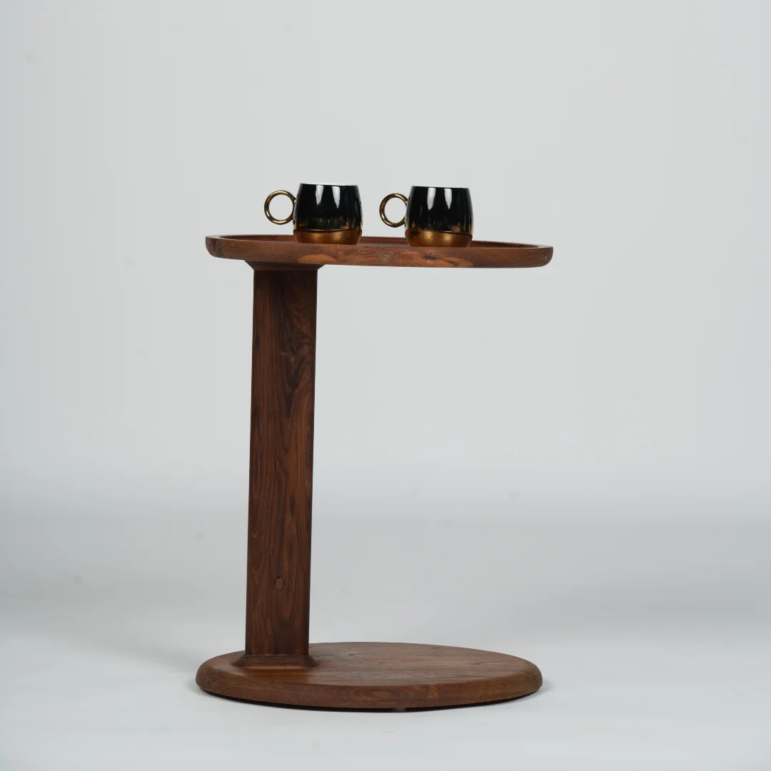 A contemporary reclaimed wood coffee table featuring a sleek, round top and a minimalist base. The table's simple design is complemented by two black coffee mugs, creating an elegant and functional piece for modern living spaces. The rich, natural wood finish adds warmth and character, making it perfect for any setting, from casual living rooms to sophisticated lounges.