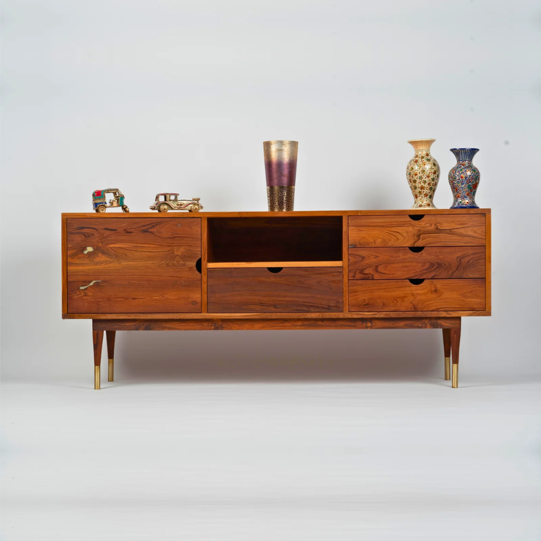 A stylish reclaimed wood console table featuring a slim profile and elegant design. The table includes drawers and an open shelf, providing ample storage while maintaining a modern aesthetic. Its natural wood finish and brass-accented legs add warmth and character, making it perfect for entryways, corridors, or hospitality spaces. The console blends functionality with refined design, highlighting the beauty of reclaimed wood.