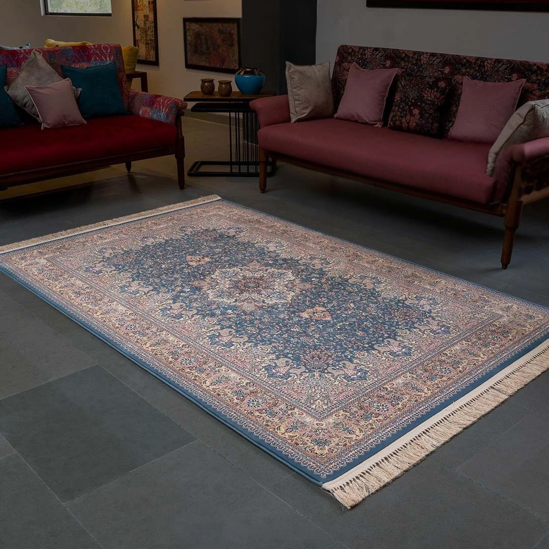 custom Kashmiri carpet with intricate blue medallion and floral patterns placed in a modern living room showcasing personalized handmade craftsmanship and premium quality rug