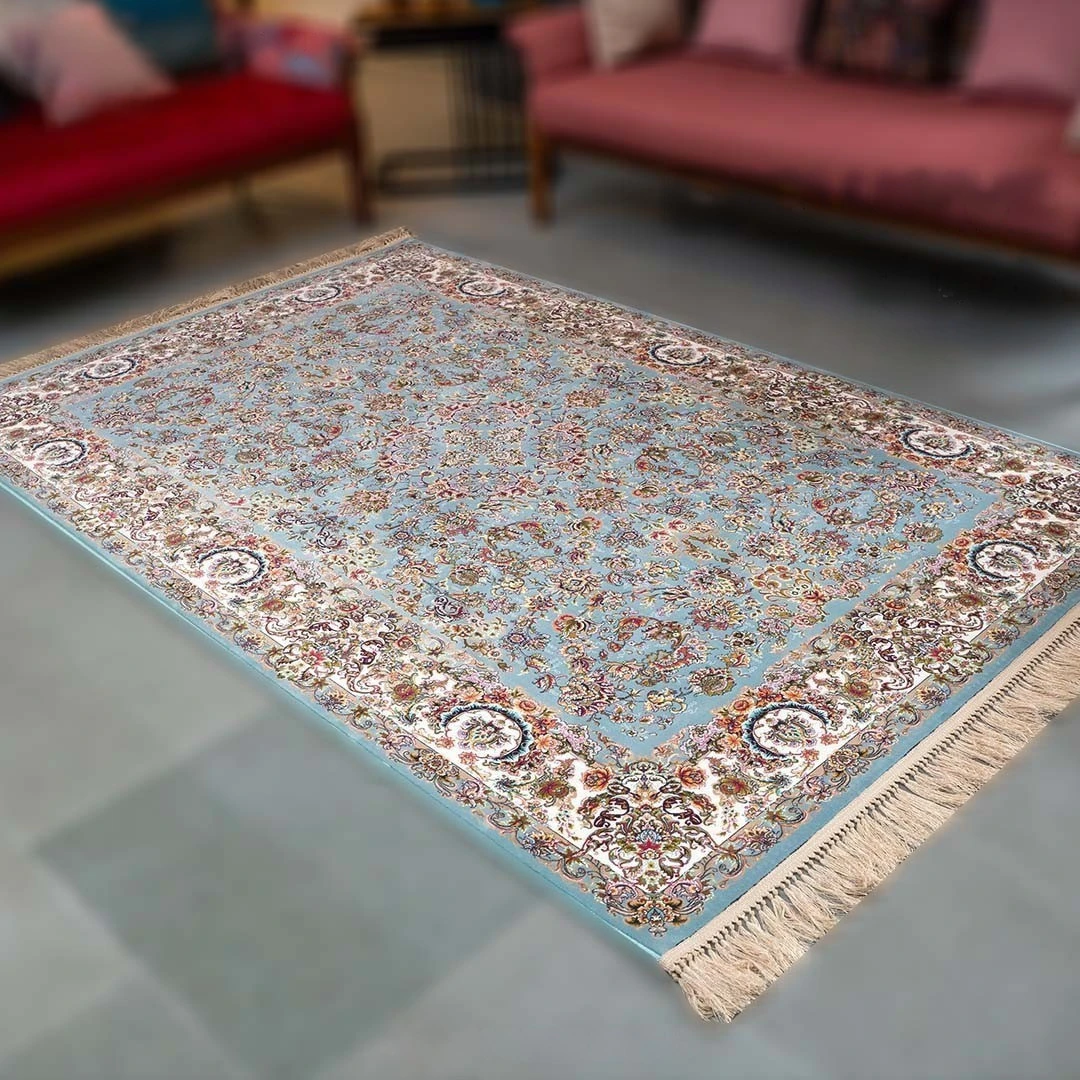 silk Kashmiri carpet with detailed floral patterns and soft blue base placed in a living room showcasing luxurious handmade craftsmanship and fine texture