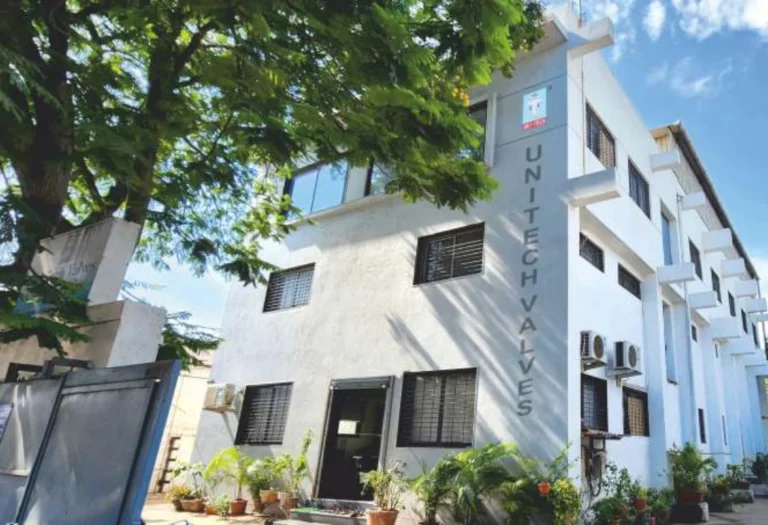 Modern facility of Unitech Valves, a leading industrial valve manufacturer and supplier in India, surrounded by greenery and industrial infrastructure.