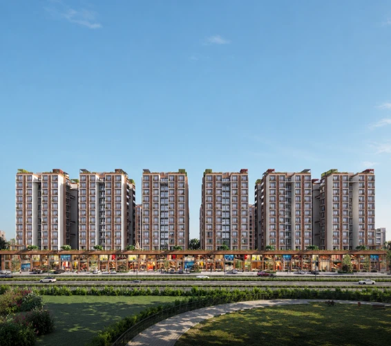 Modern high-rise residential apartments developed by a leading construction company in Ahmedabad with landscaped surroundings and commercial frontage.